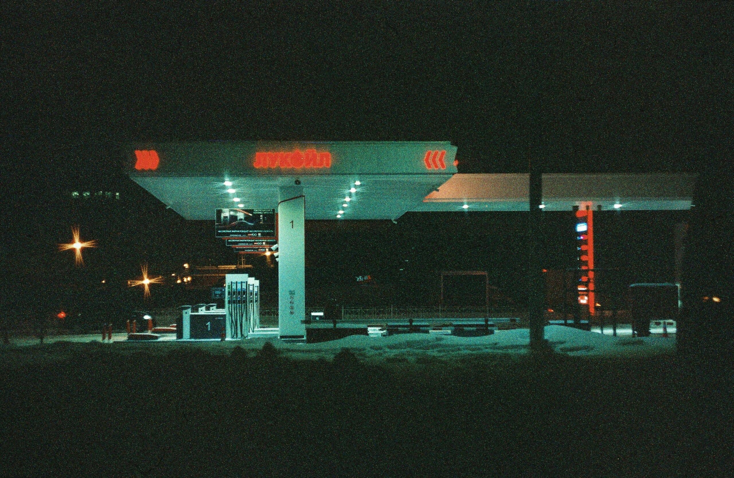 Fuel station forecourt at night